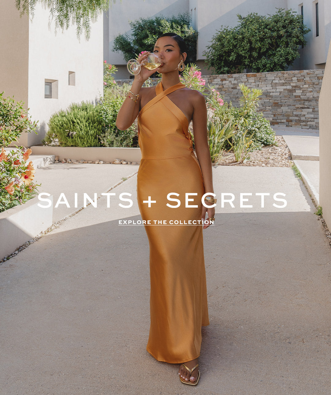 Saints & Secrets banner - model wearing yellow satin dress