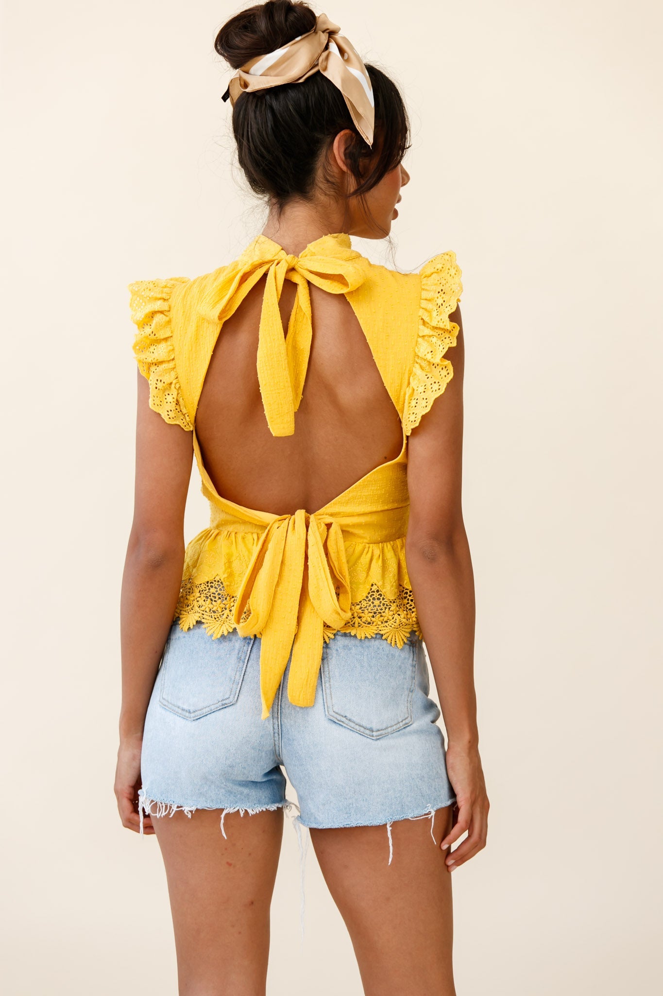 Gracious Sleeveless Open Back Peplum Top Yellow by Selfie Leslie
